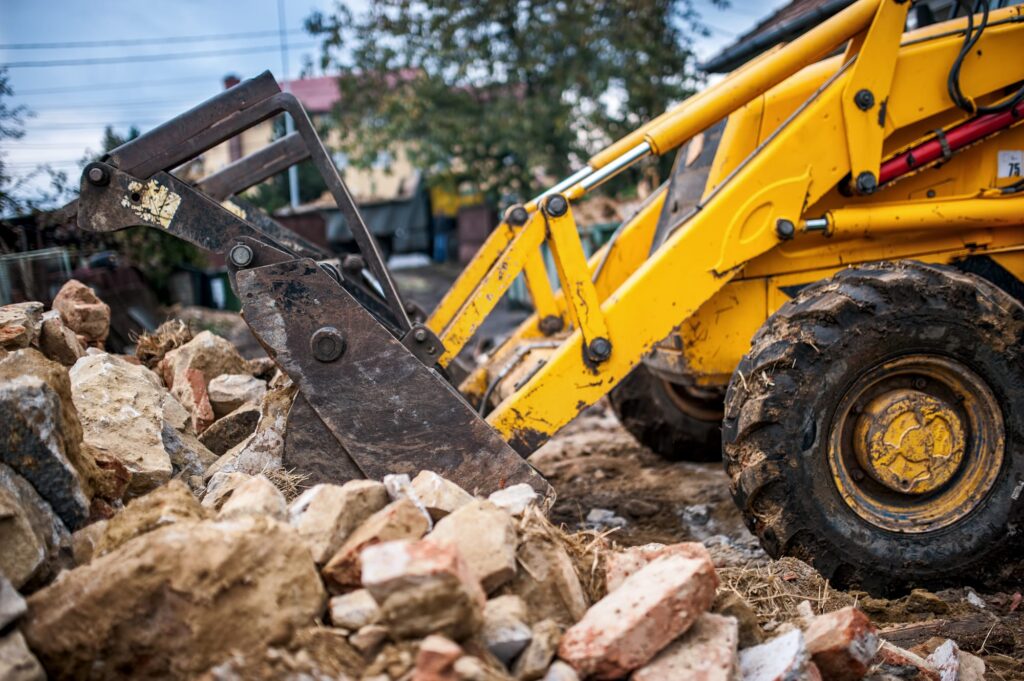 Loader removing rubble and construction waste during professional site preparation works
