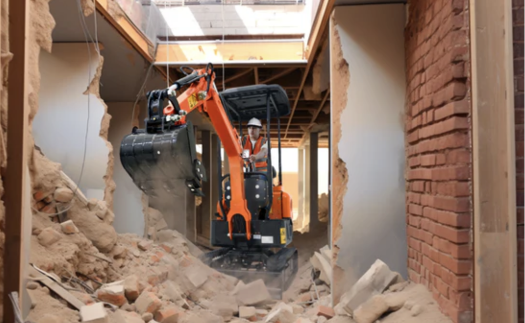 Compact excavator operating in a narrow corridor during tight space demolition, safely removing structural materials in a restricted area.