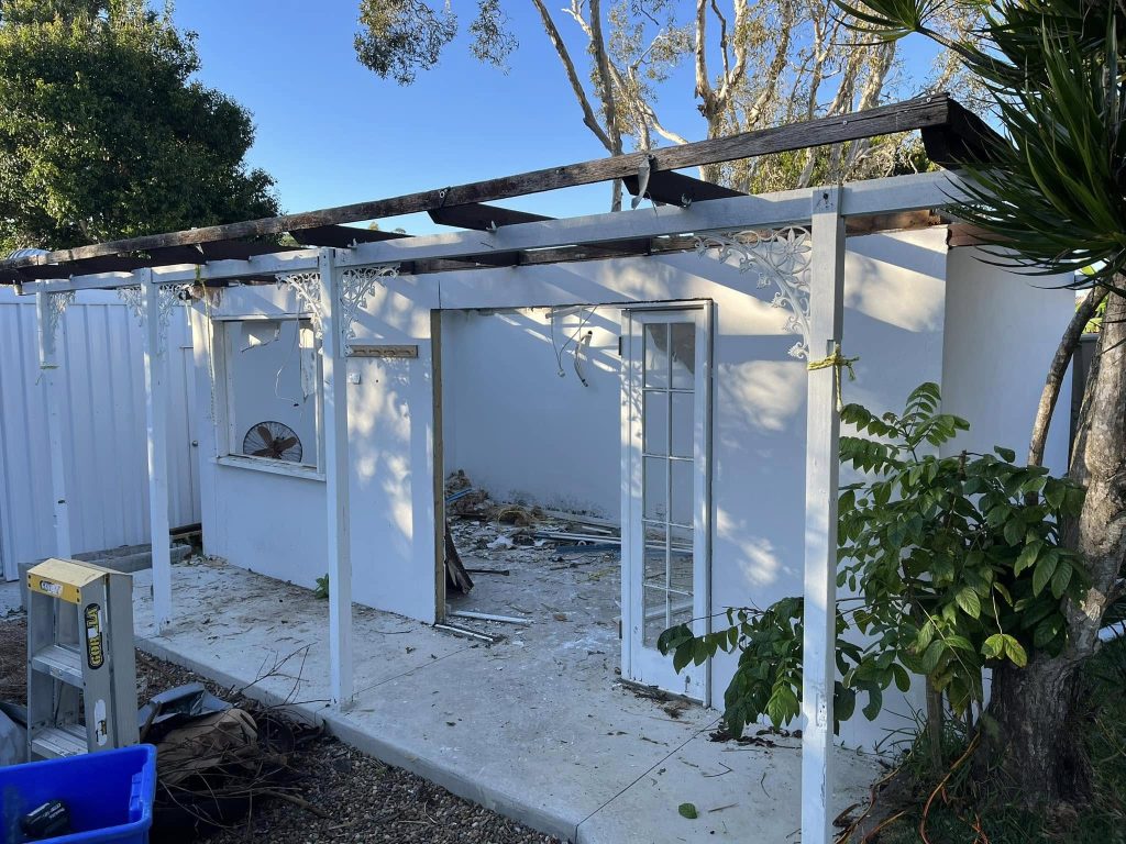 Partially demolished backyard structure prepared for safe residential demolition